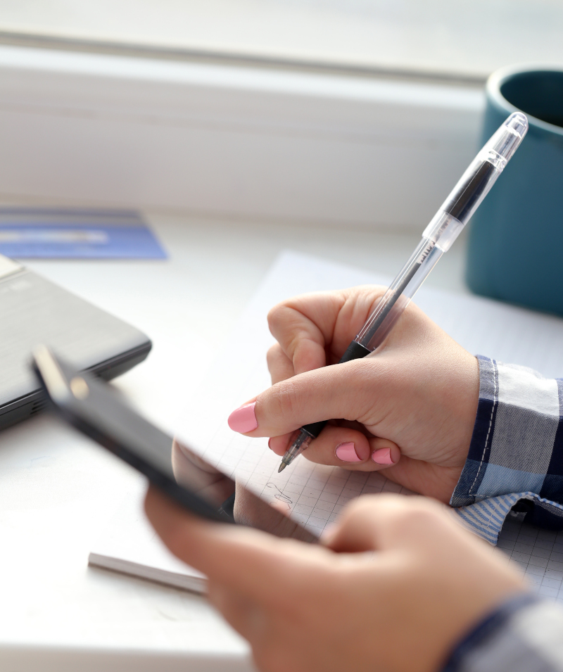 Woman with notebook and a phone